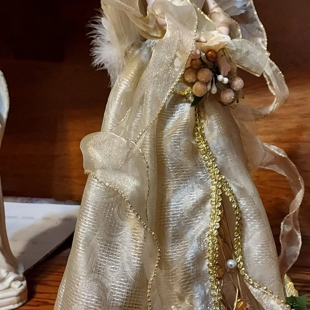 BEAUITFUL ANGLE HOLDING FLOWERS AND A BIRD IN HER HAND